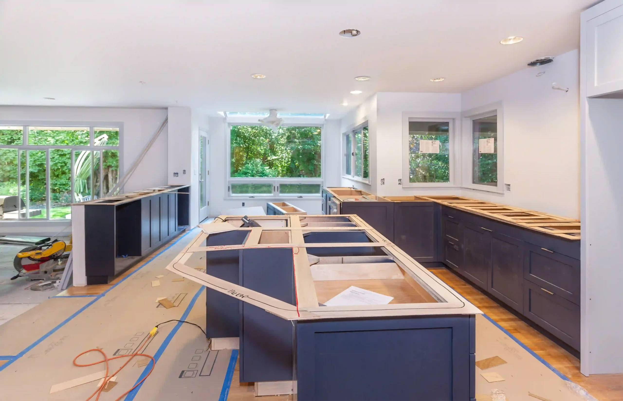 Kitchen under renovation with dark cabinetry and open space, showcasing potential for custom modern designs by JL Coastal Projects.