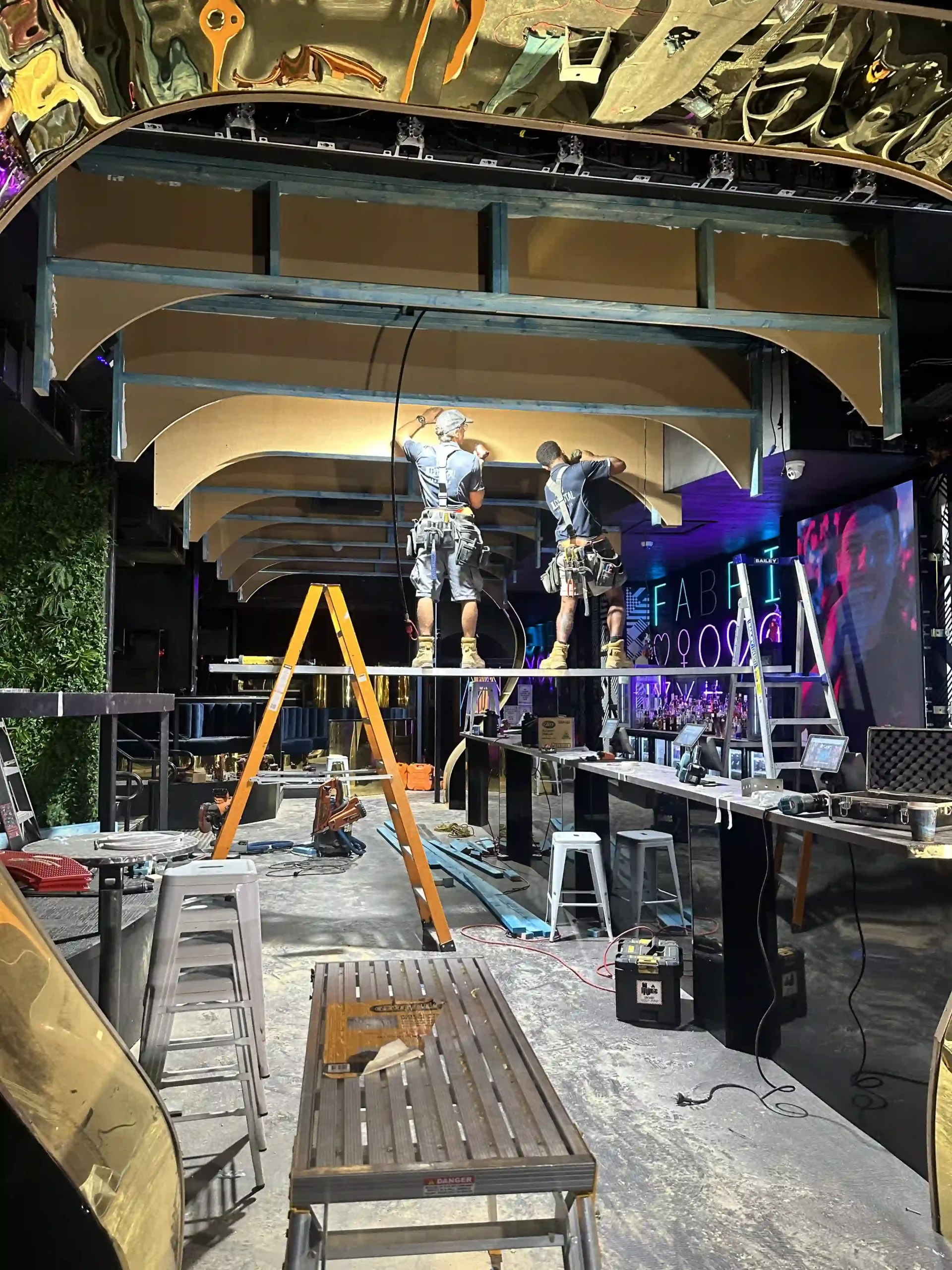 JL Coastal Projects working on the ceiling renovation and lighting installation at a nightclub.